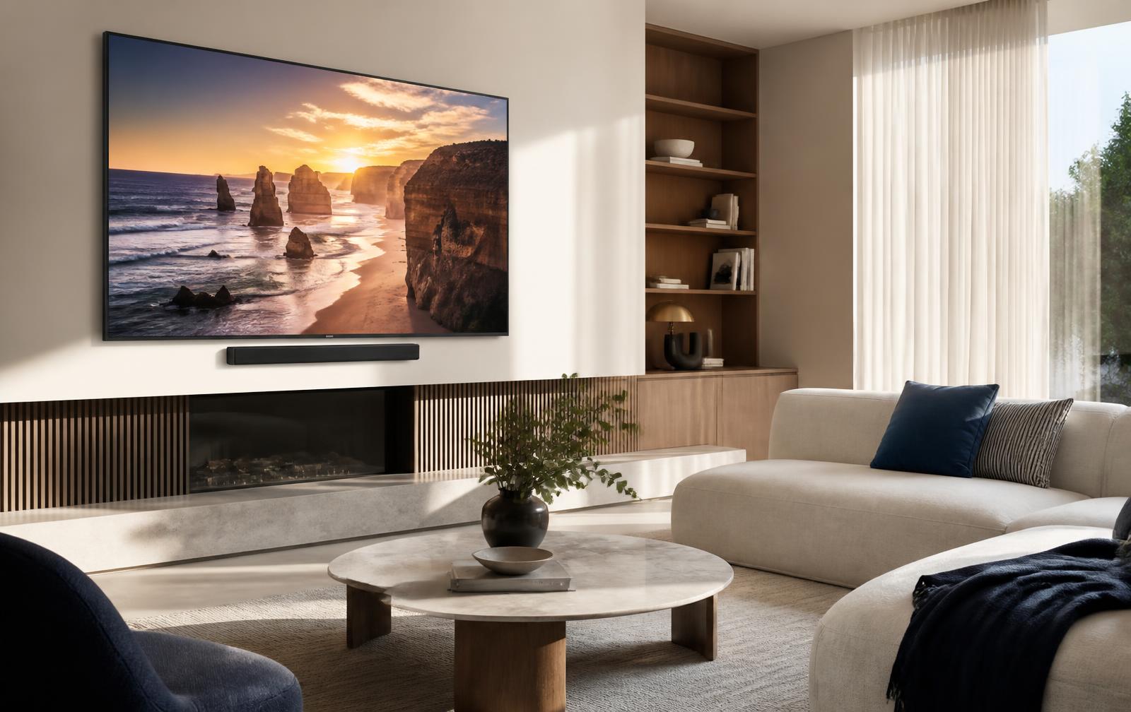 Large OLED television mounted in a bright modern Australian living room with a linen sofa